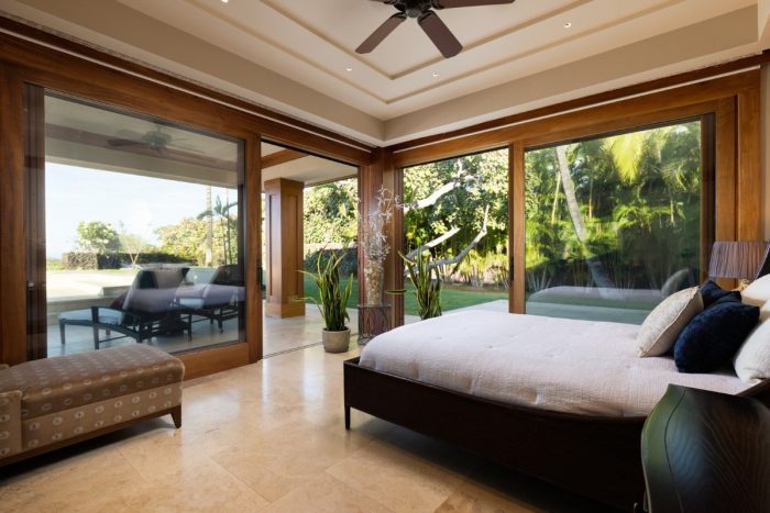 Guestroom with double sliding door to patio with outdoor table and chairs