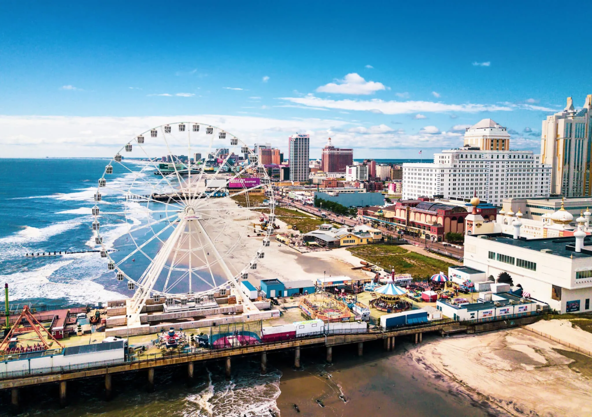 Beach pier with Ferris wheel and ocean backdrop