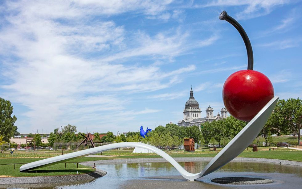 Cherry and spoon sculpture in a park